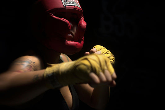 woman wearing headgear that has been cleaning with a boxing glove deodoriser spray