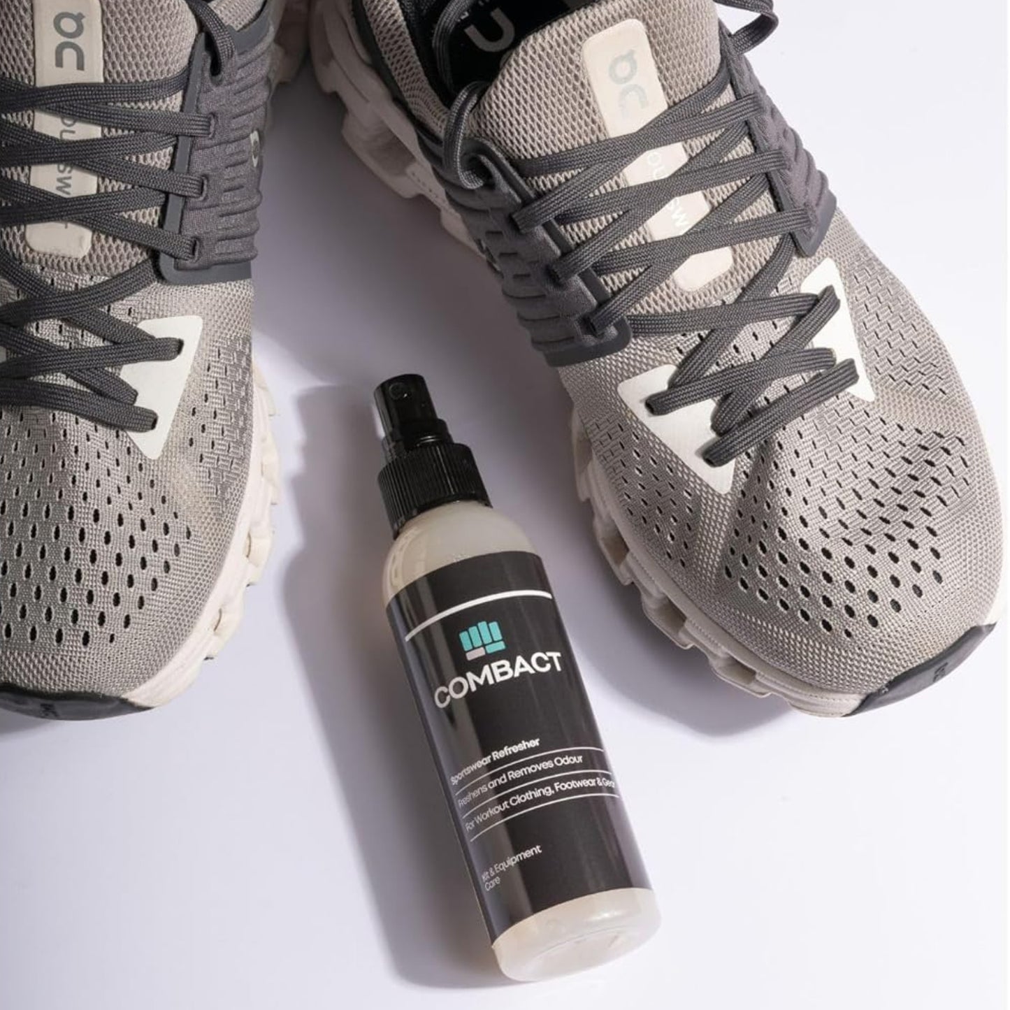 Photograph of a pair of running trainers and a deodoriser spray, the Sportswear Refresher by Combact.